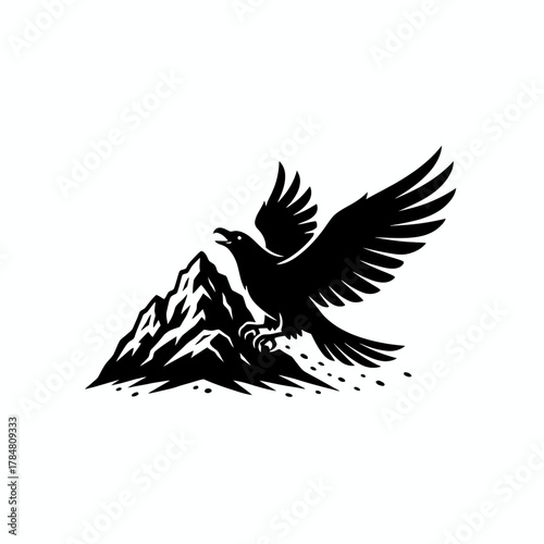 Black silhouette of an eagle landing on a mountain peak with its wings spread wide and beak open
