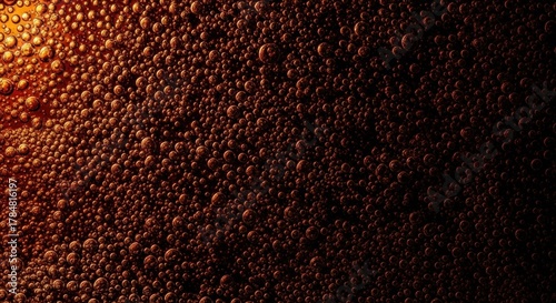 Abstract macro view of carbonated bubbles. Rich amber texture with dramatic lighting effect. Effervescent soda or beer concept for marketing. Dynamic organic pattern for a luxury backdrop