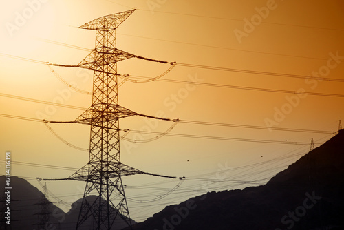 Dramatic power lines against warm gradient sky for infrastructure projects