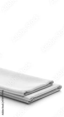 Crisp white cloth napkin folded simply on a seamless white backdrop, emphasizing cleanliness and elegance and purity ,tableware ,linen ,textile