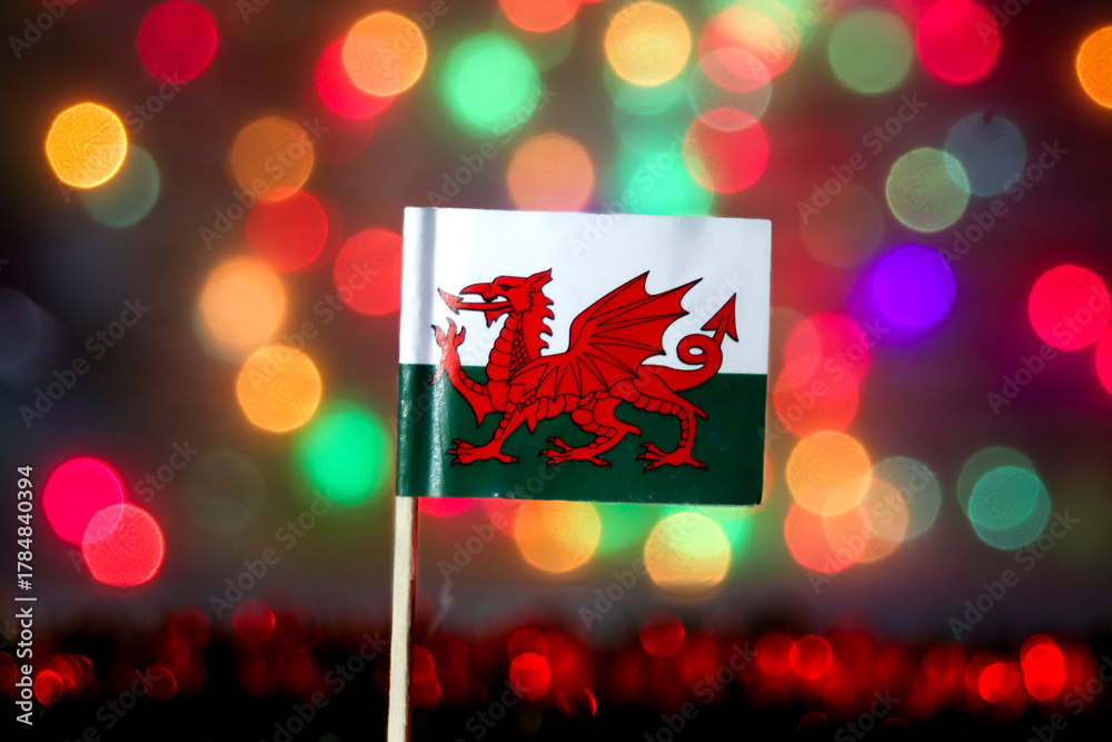 Φωτογραφία The Welsh national flag (Y Ddraig Goch) with its red dragon, set against a vibrant, defocused bokeh background
