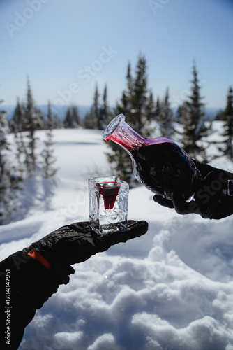 An exclusive shot for serving outdoors in winter, pouring red wine