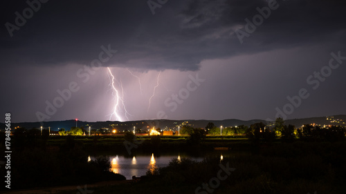 Multiple lightning during thunderstorm at night, over hills near croatian city of Slavonski Brod