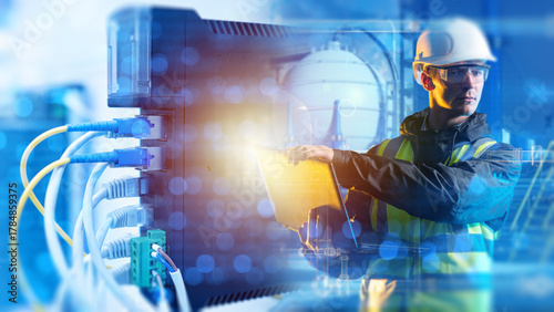 Bild auf Leinwand Industrial automation engineer configures network systems and monitors digital equipment for smart factory and process optimization