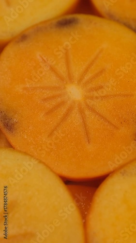 Slices persimmon close up, rotation