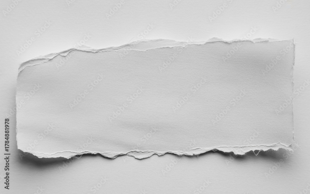 Obraz premium Torn edge of white paper on a white background creating a minimalist and textured backdrop for graphic design projects and artistic presentations with subtle shadows