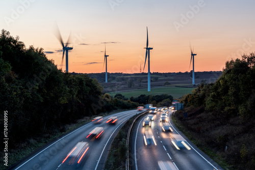 Wind turbines and highway traffic creating renewable energy concept