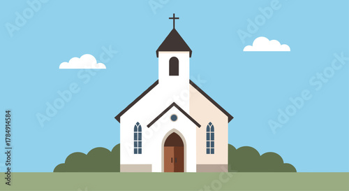 Serene white chapel with steeple and cross stands against a clear blue sky with fluffy clouds and green foliage