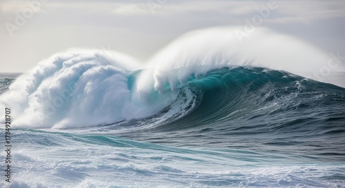 Fototapeta Naklejka Na Ścianę i Meble -  Massive ocean wave breaking in a powerful swell. The raw force of nature and untamed energy. A metaphor for challenge risk and opportunity. Dramatic seascape with turbulent sea