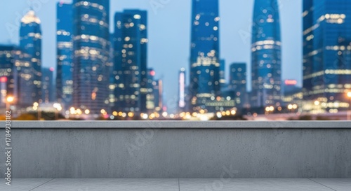 A modern city skyline at dusk with a concrete ledge in the foreground.