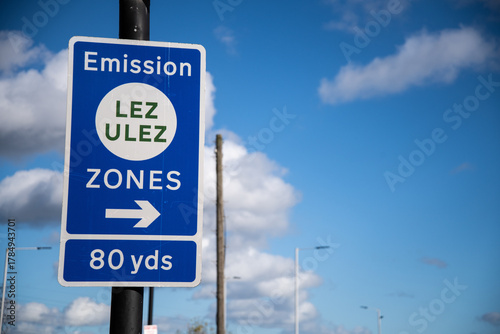 Blue “ULEZ → 80 Yards” road sign in London, England, directing drivers toward the Ultra Low Emission Zone, symbolizing clean air policy.