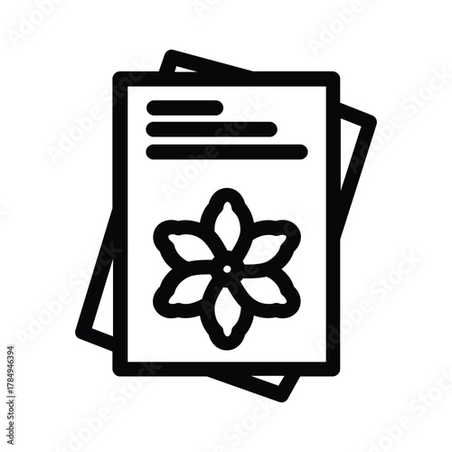 Two rectangular papers one on top The top has lines a flower