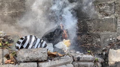 4k video footage of People burns waste and makes a lot of smoke which can cause air pollution. Concept for environmental damage.	
