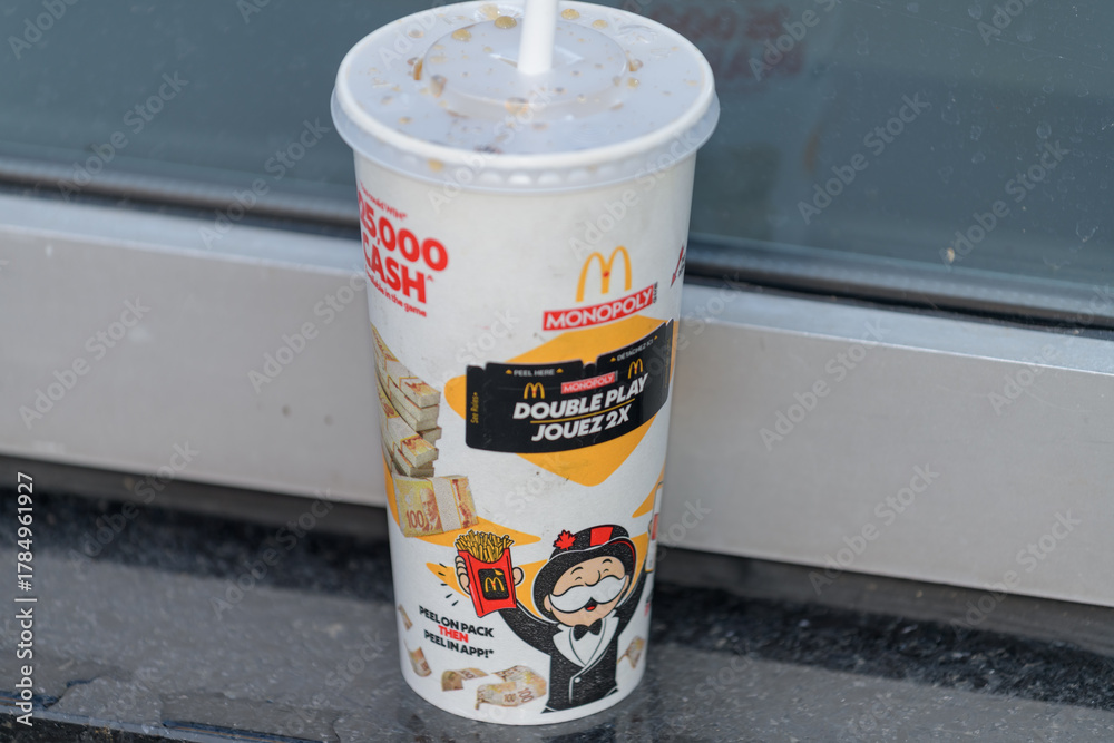 Naklejka premium McDonald's Canada beverage cup with Monopoly promotional event graphic design outdoors in Toronto
