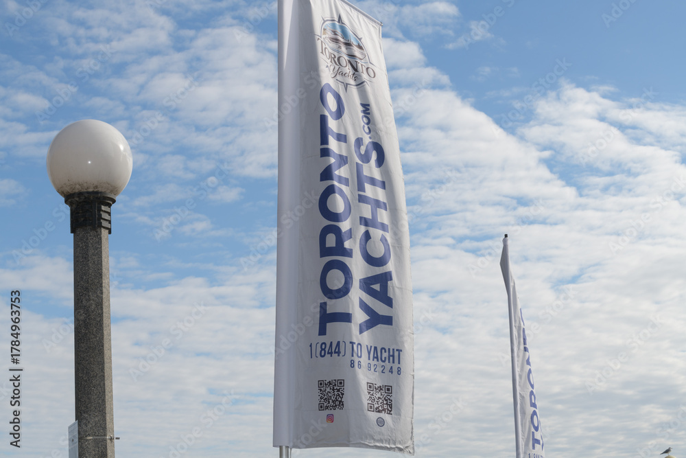Fototapeta premium Toronto Yachts (a boat rental service) banners on a cloudy blue sky 
