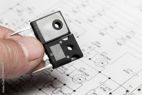 Two transistors against the background of a circuit diagram