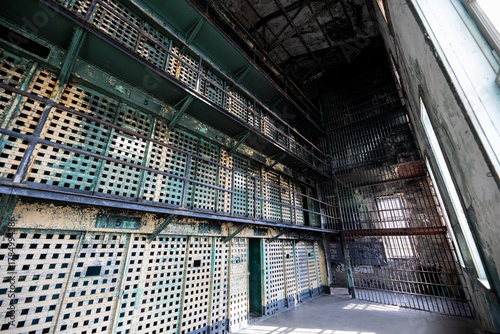 A prison cell block with bars on the windows
