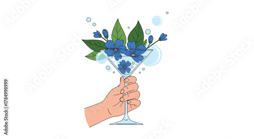 A hand holding a martini glass filled with blue flowers and green leaves.