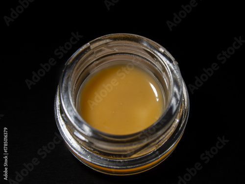 Obraz na plátně Close up macro cannabis oil concentrate dab on black background