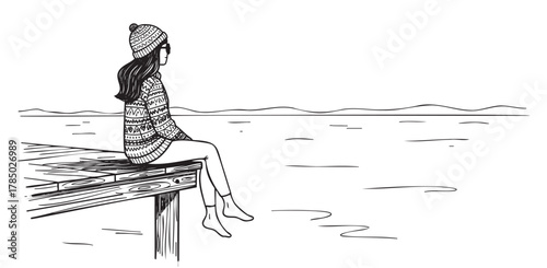 Young caucasian female in a patterned sweater and hat sits on a wooden dock, looking out over a calm lake, with distant hills on the horizon.