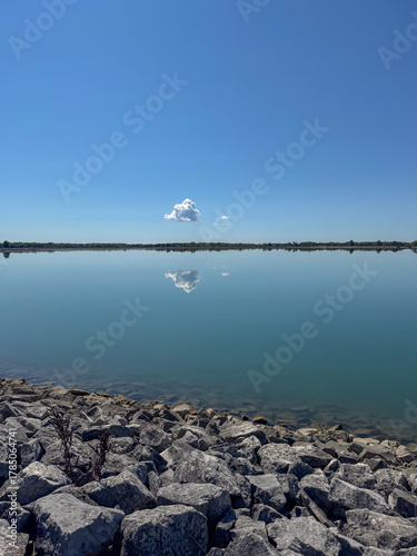 white cloud reflection over blue lake 
