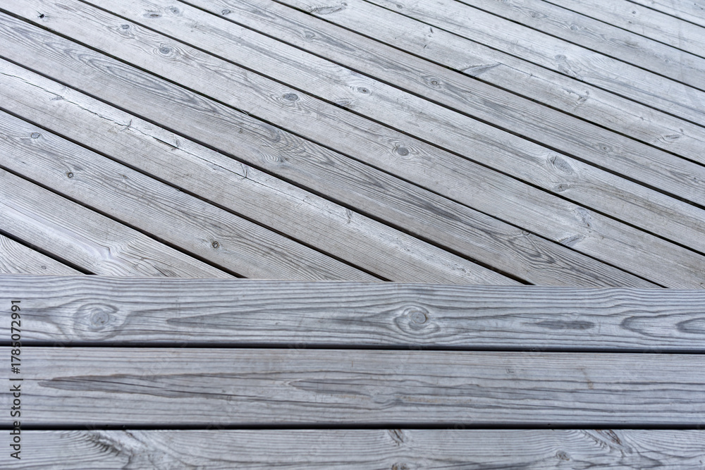 Obraz premium Close-up view of weathered gray wooden deck with natural patterns and textures 