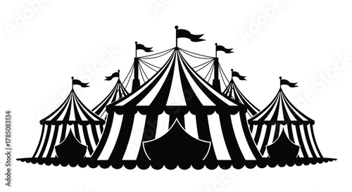 A collection of striped tents and flags on a flat surface.