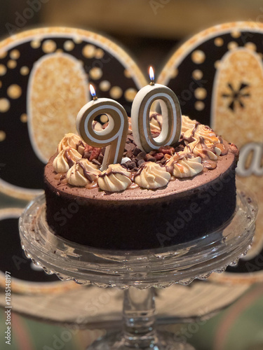 chocolate cake on a plate ninety birthday candles