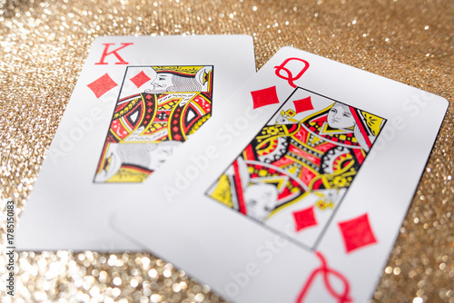 Photograph of a set of king and queen playing cards on a gold background