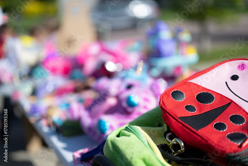 Pile of secondhand cloths on a folding table of a yard sale