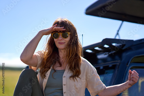 Ginger woman with sunglasses on Safari