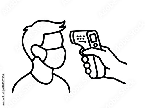 Person wearing a face mask is having their temperature checked with an infrared thermometer.