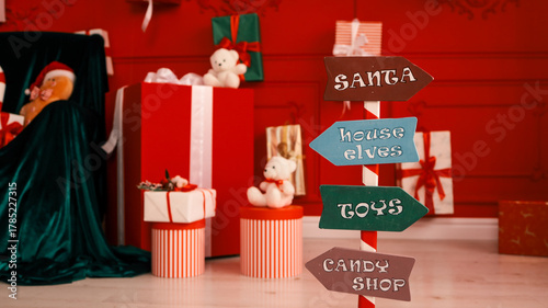 Quadro em tela Christmas signpost pointing to Santa, house elves, toys, and candy shop