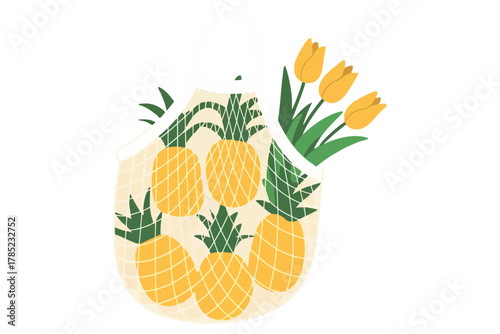 A reusable grocery bag is filled with pineapples and yellow tulips
