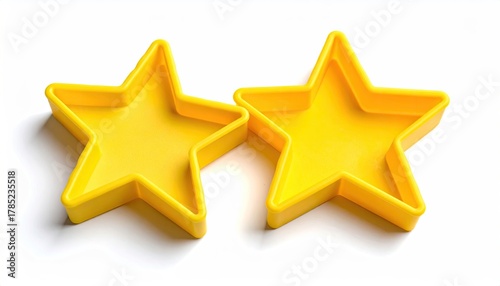Two vibrant yellow, five-pointed star-shaped molds are presented against a stark white backdrop, positioned closely together