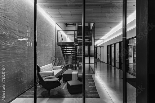 Black and white abstract of office entrance at night with reflections
 