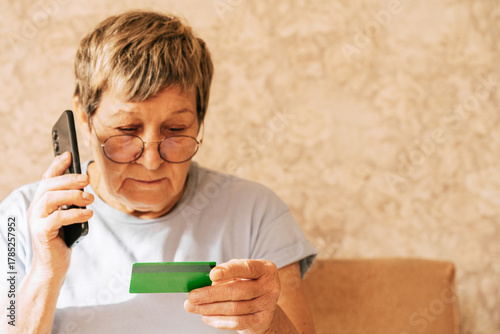 A naive elderly woman gives her bank card details to telephone scammers. Financial fraud using personal information, manipulation, criminal activity