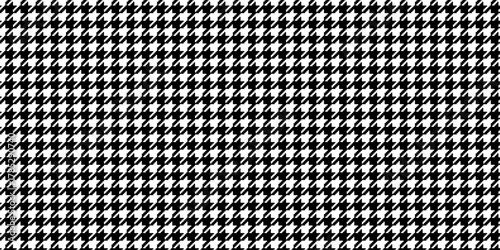 Houndstooth plaid pattern. Black and white dogtooth texture. Retro tweed textile print for scarf or cloth. Classic geometric design with pied de poule effect. Vector graphic illustration.