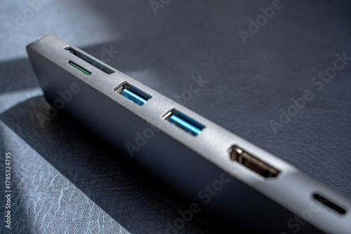 Photograph of a metallic gray USB hub focusing on the memory card slots