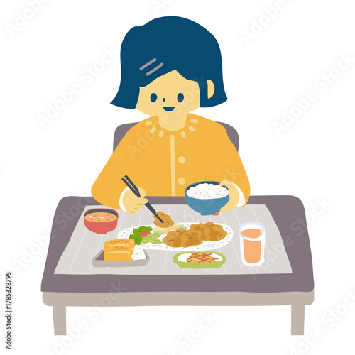 唐揚げ定食を食べる女性