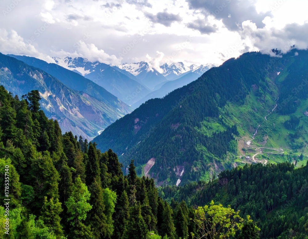 Fototapeta premium Verdant mountain range under cloudy sky, scenic view