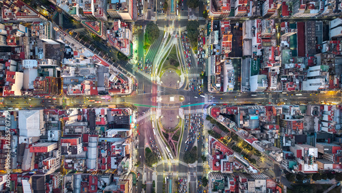 Aerial top-down view of Obelisco with traffic light trails at night, Buenos Aires, Argentina.
