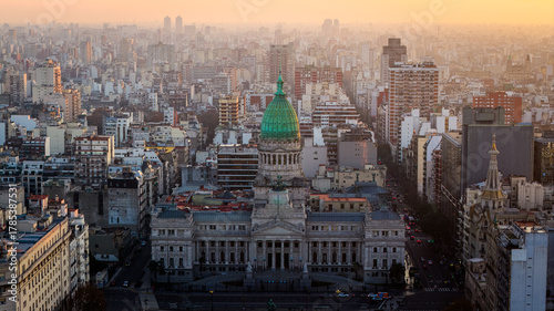 Aerial sunset view of National Congress building with green dome and Buenos Aires cityscape, Argentina.
