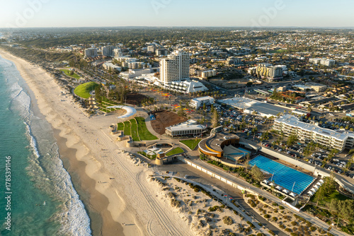 Aerial view of a busy coastal suburb and beachside precinct
