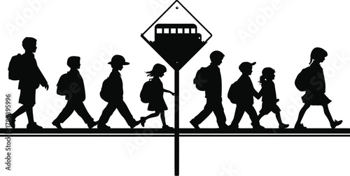 Silhouette of children crossing the street at a school bus stop sign