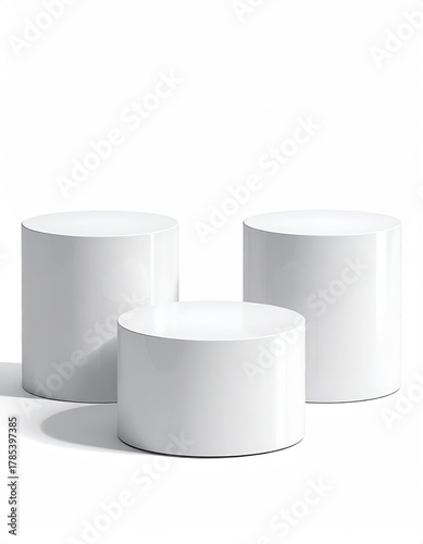 Three white, staggered, cylindrical platforms on a white backdrop