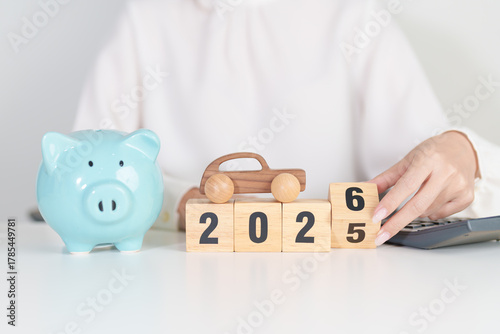 2025 end year to Happy New Year 2026 with car model and Coins Money stack for deposit and Automobile Tax. Money Saving, Car Insurance, Financial, vehicle Repair and Maintenance and New Year concept