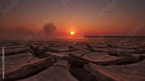 Sunset or sunrise over the cracked earth landscape