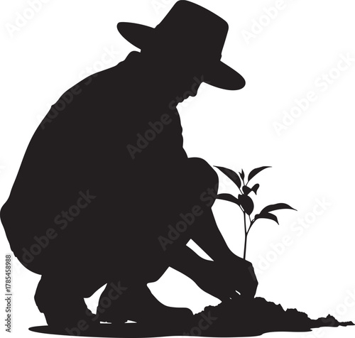 Farmer planting a sapling in silhouette