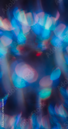 Blur round lens. Rainbow leak. Colorful light glow blend on defocused abstract dark background. Neon luminosity green blue red texture.